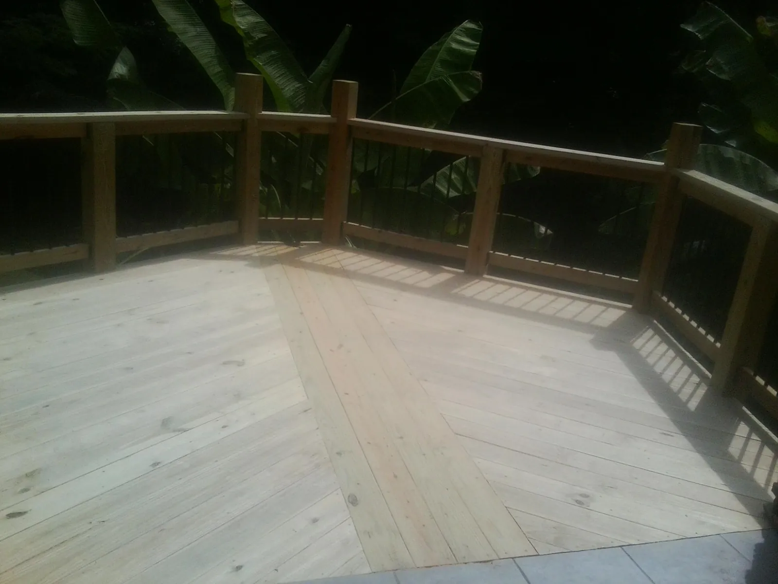New wood deck and railing built off the back of a home in Trappe