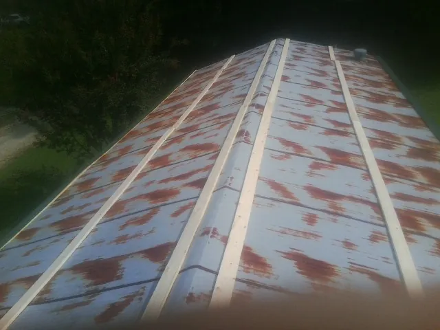 Rusted metal roof panels with new wood purlins before replacement — Storm Damage Roof Repair in Trappe by Roofing Brothers